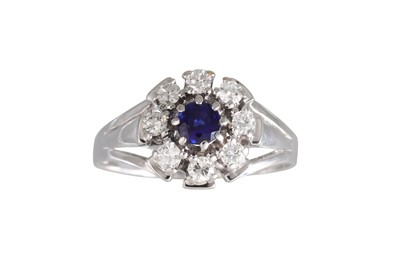 Lot 279 - A SAPPHIRE AND DIAMOND CLUSTER RING, set with...
