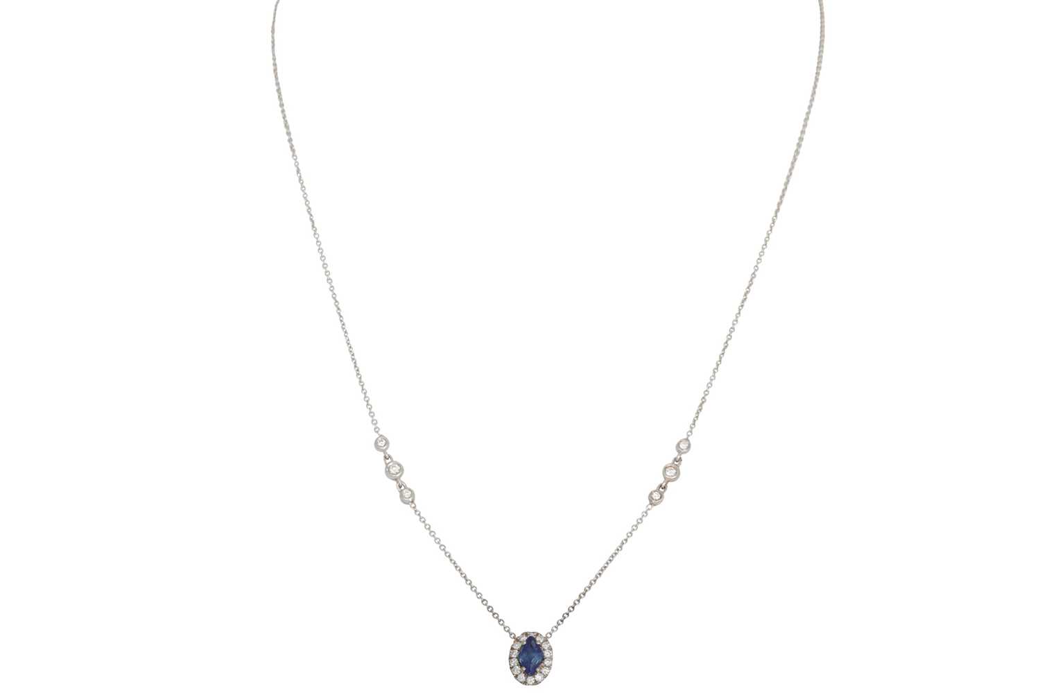 Lot 326 - A SAPPHIRE AND DIAMOND CLUSTER PENDANT, the...