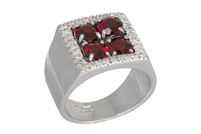 Lot 336 - A GARNET AND DIAMOND CLUSTER RING, the four...