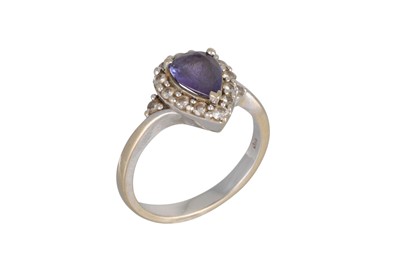 Lot 136 - A TANZANITE AND DIAMOND CLUSTER RING, the pear...