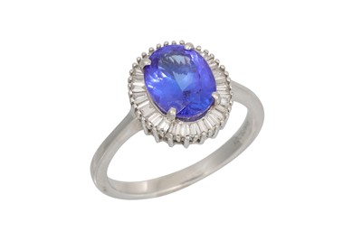 Lot 356 - A TANZANITE AND DIAMOND CLUSTER RING, the oval...