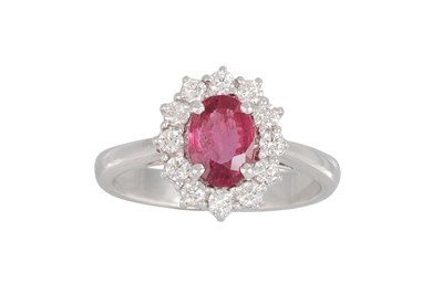 Lot 198 - A RUBY AND DIAMOND CLUSTER RING, the oval ruby...
