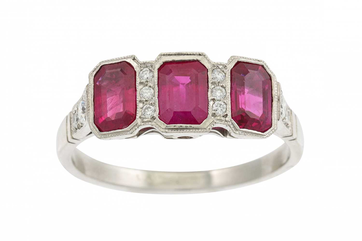 Lot 356 - A RUBY AND DIAMOND RING, set with three trap...