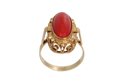 Lot 323 - A RED CORAL RING, the cabochon stone mounted...