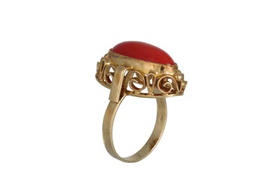 Lot 163 - A RED CORAL RING, the cabochon stone mounted...