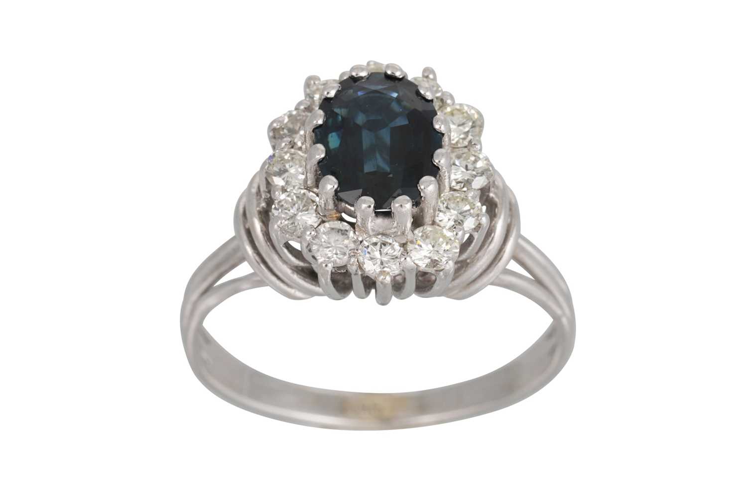 Lot 164 - A SAPPHIRE AND DIAMOND CLUSTER RING, the oval...