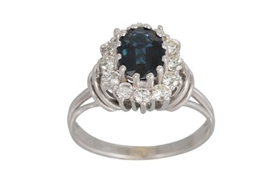 Lot 324 - A SAPPHIRE AND DIAMOND CLUSTER RING, the oval...