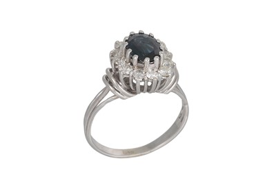 Lot 263 - A SAPPHIRE AND DIAMOND CLUSTER RING, the oval...