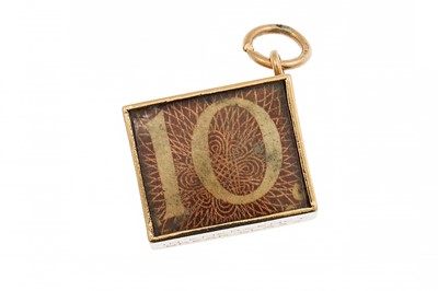 Lot 360 - A VINTAGE GOLD CHARM, containing a 10 - note
