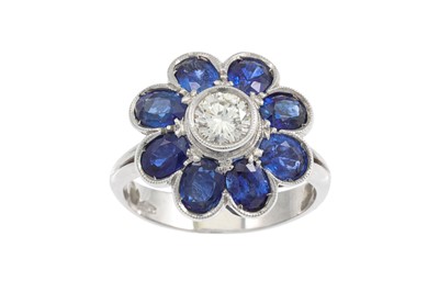 Lot 274 - A DIAMOND AND SAPPHIRE FLOWER CLUSTER RING,...