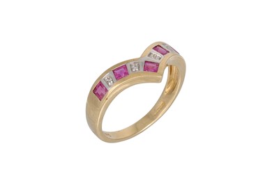 Lot 38 - A DIAMOND AND RUBY ETERNITY RING, the shaped...