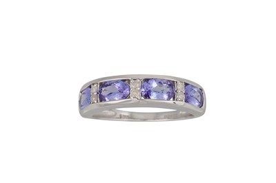 Lot 76 - A FOUR STONE TANZANITE AND DIAMOND RING, the...