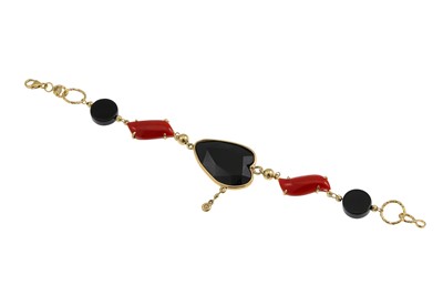 Lot 280 - A CORAL AND ONYX BRACELET, suspending one...