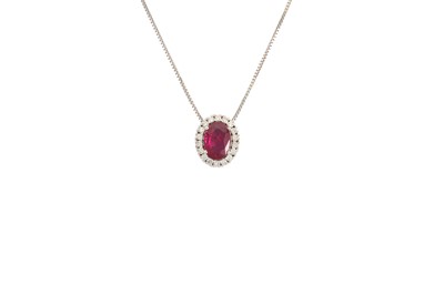 Lot 288 - A RUBY AND DIAMOND PENDANT, the oval ruby to a...