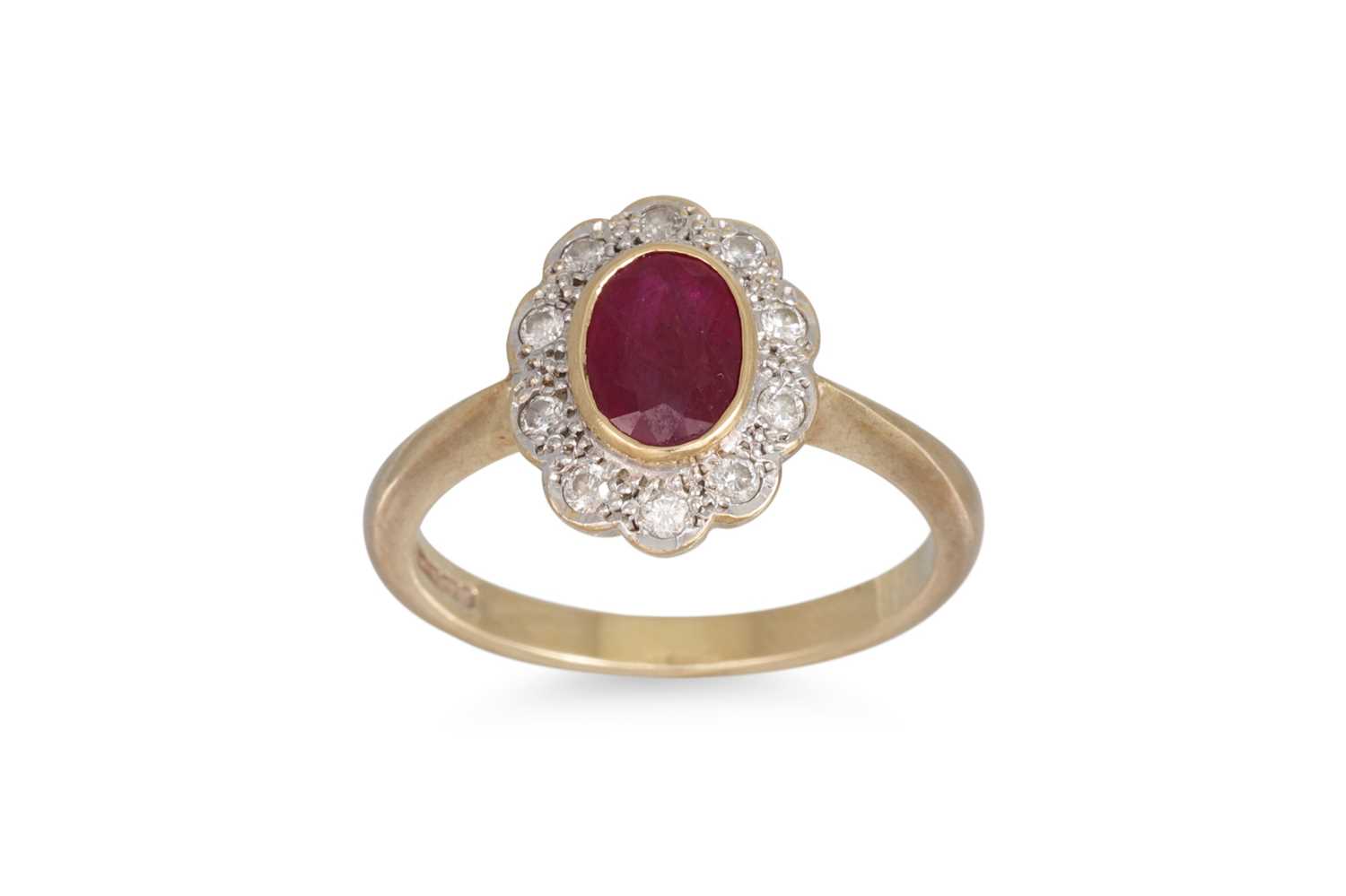 Lot 61 - A RUBY AND DIAMOND CLUSTER RING, of oval form,...