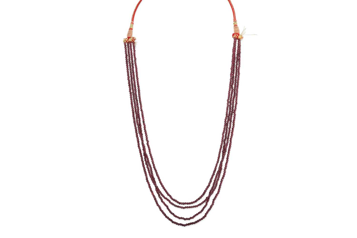 Lot 69 - A BEADED RUBY FOUR STRANDED NECKLACE, on a...