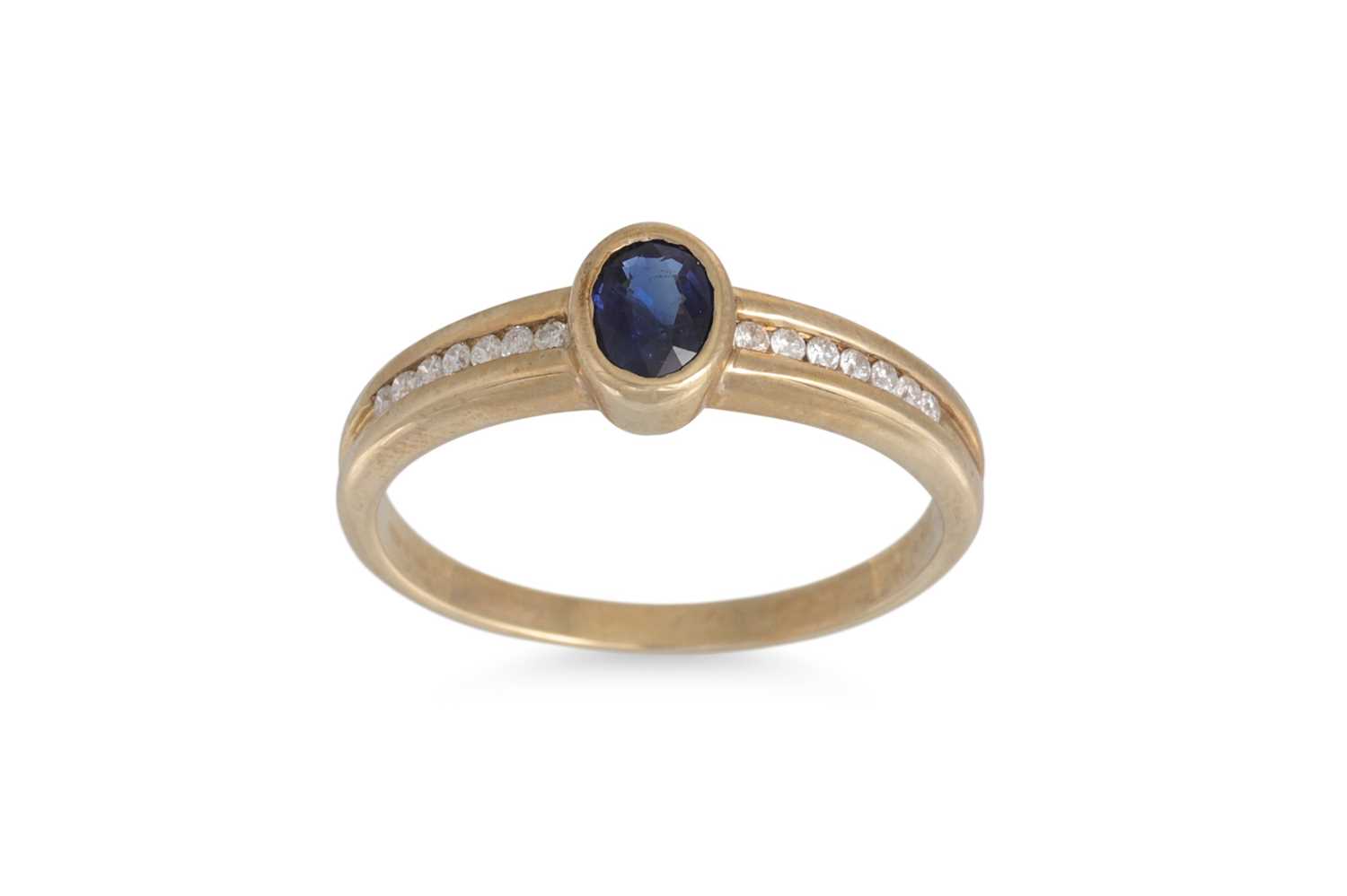 Lot 216 - A SAPPHIRE AND DIAMOND RING, the oval sapphire...