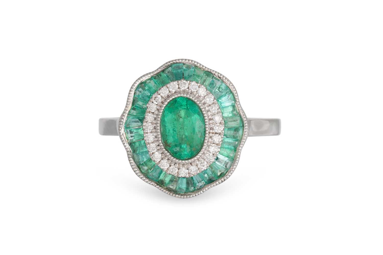 Lot 53 - A DIAMOND AND EMERALD CLUSTER RING, the oval...