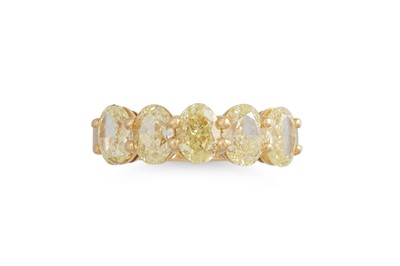 Lot 198 - A YELLOW DIAMOND FIVE STONE RING, the oval...