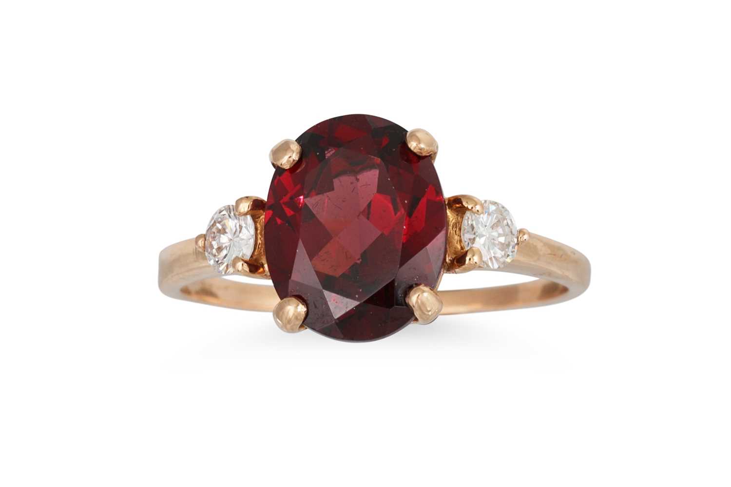Lot 314 - A GARNET AND DIAMOND DRESS RING, the oval...