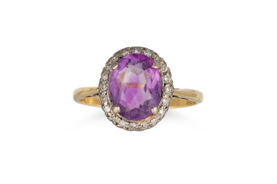Lot 76 - A DIAMOND AND AMETHYST CLUSTER RING, the oval...