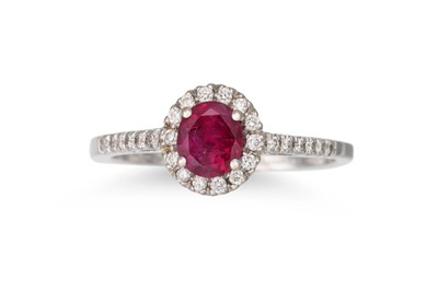 Lot 232 - A DIAMOND AND RUBY CLUSTER RING, the circular...