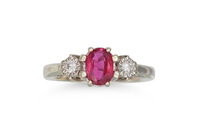 Lot 229 - A DIAMOND AND RUBY THREE STONE RING, the oval...