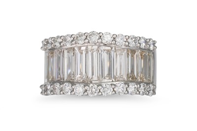 Lot 258 - A THREE ROWED DIAMOND RING, set with baguette...