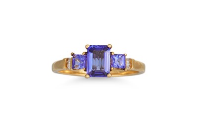 Lot 390 - A THREE STONE TANZANITE RING, diamond...