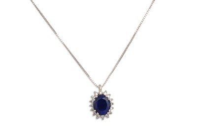 Lot 369 - A DIAMOND AND SAPPHIRE CLUSTER PENDANT, the...