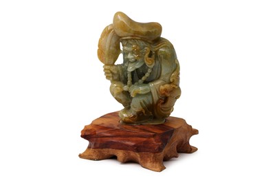 Lot 483 - A CHINESE CARVED JADE FIGURE, of a crouching...