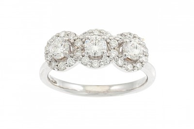 Lot 309 - A DIAMOND TRIPLE HALO CLUSTER RING, the...