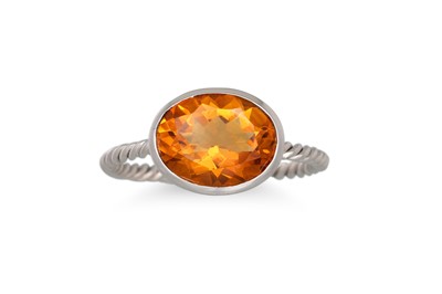 Lot 176 - A CITRINE RING, the oval citrine mounted in...