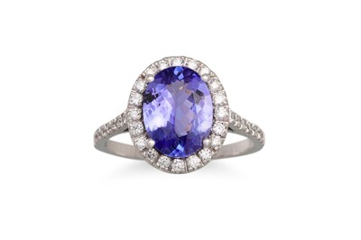 Lot 178 - A TANZANITE AND DIAMOND RING, the oval...