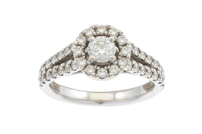 Lot 405 - A DIAMOND CLUSTER RING 'Hearts on fire', set...