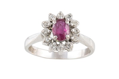Lot 23 - A RUBY AND DIAMOND CLUSTER RING, mounted in...
