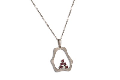 Lot 146 - A DIAMOND AND RUBY PENDANT, mounted in white...