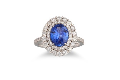 A DIAMOND AND SAPPHIRE CLUSTER RING, the oval...