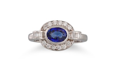 Lot 174 - A SAPPHIRE AND DIAMOND CLUSTER RING, the oval...