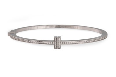 Lot 120 - A DIAMOND SET BANGLE, hinged form, mounted in...