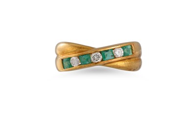 Lot 80 - AN EMERALD AND DIAMOND CROSS OVER RING,...