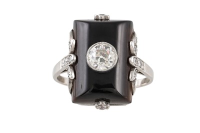 Lot 416 - AN ONYX AND DIAMOND PLAQUE RING, in a white...