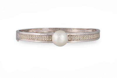 Lot 235 - A CULTURED PEARL AND DIAMOND BANGLE, hinged...