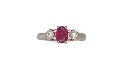 Lot 219 - A THREE STONE DIAMOND AND RUBY RING, the oval...