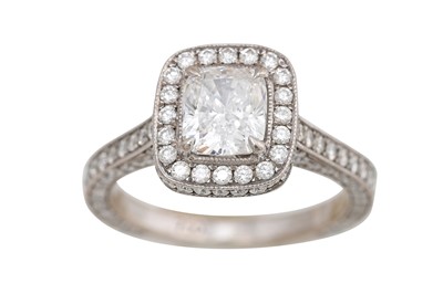 Lot 380 - A DIAMOND CLUSTER RING, the central cushion...