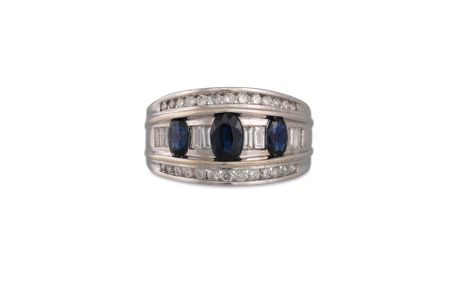 Lot 101 - A DIAMOND AND SAPPHIRE THREE ROWED RING, the...