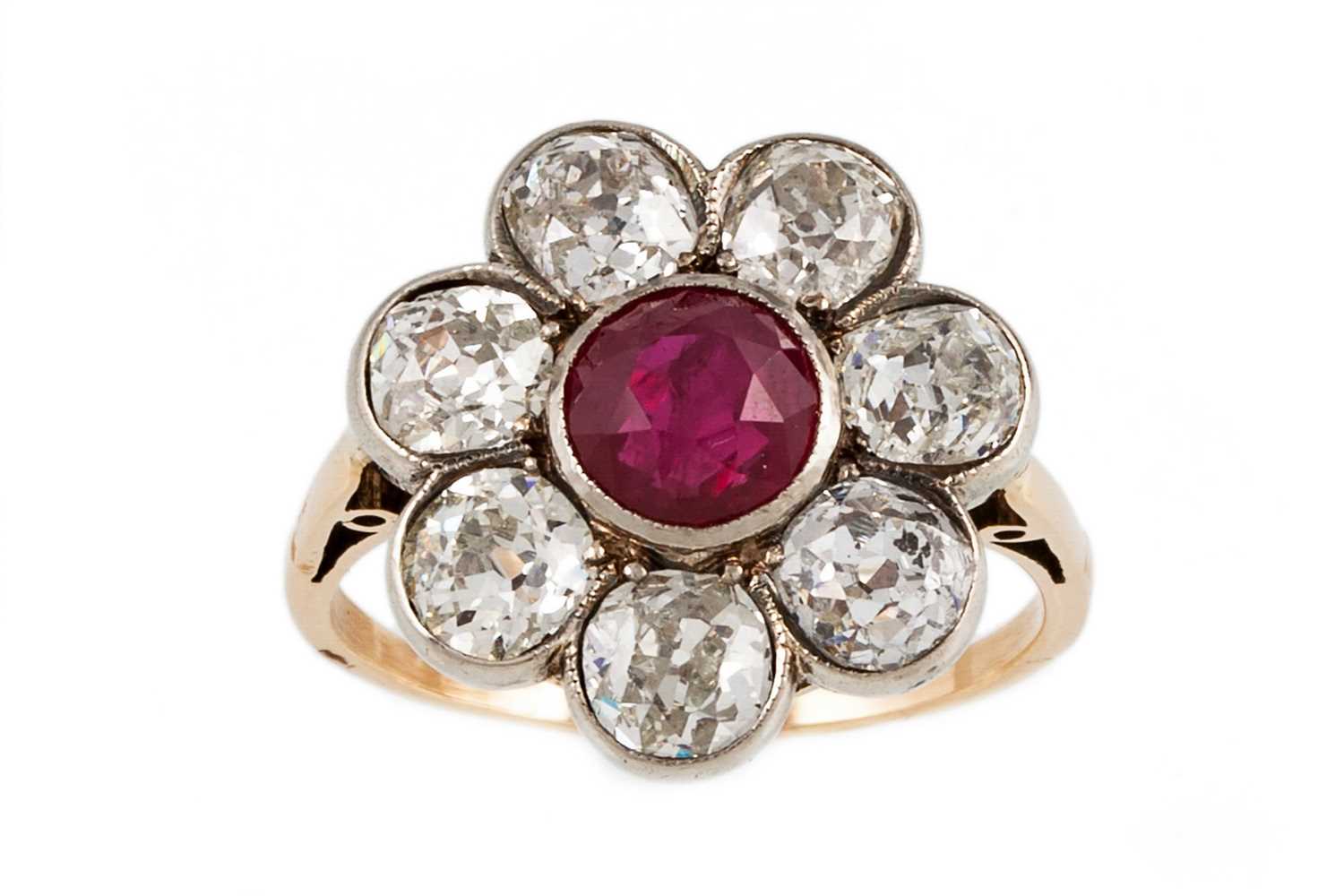 Lot 345 - A RUBY AND DIAMOND CLUSTER RING, the circular...