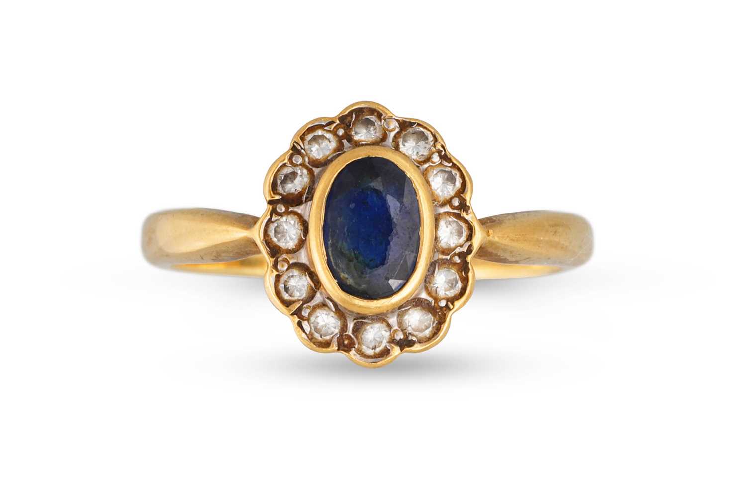 Lot 121 - A SAPPHIRE AND DIAMOND CLUSTER RING, the oval...