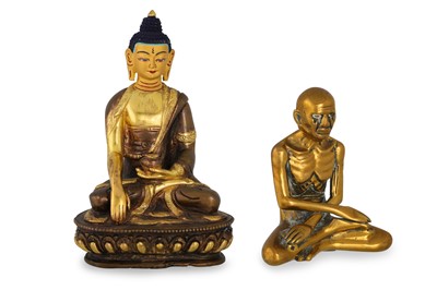 Lot 559 - A GILT AND PATINATED BRONZE FIGURE OF BUDDHA,...