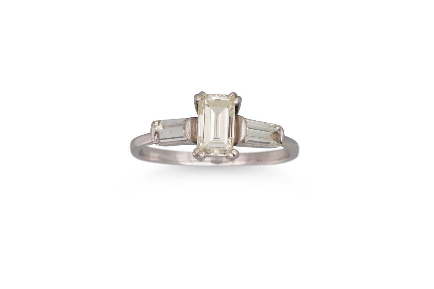Lot 380 - A DIAMOND SOLITAIRE RING, the emerald cut...